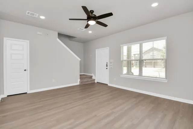 a view of a kitchen with a sink and wooden floor