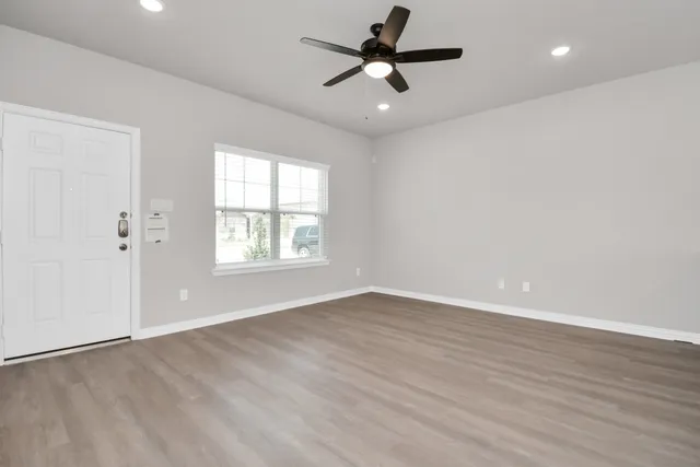 a view of walk in closet with empty racks
