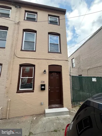 a front view of a house with parking space