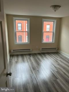 226 South Regester Street Baltimore, MD 21231 - Photo 11 of 17 an empty room with wooden floor and windows