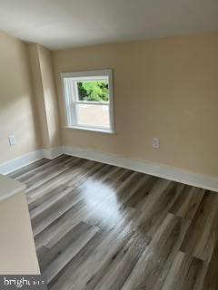 226 South Regester Street Baltimore, MD 21231 - Photo 13 of 17 an empty room with wooden floor and windows