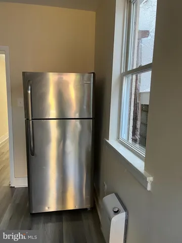 a view of a refrigerator in kitchen and an entryway