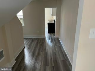 226 South Regester Street Baltimore, MD 21231 - Photo 7 of 17 wooden floor in an empty room with a window