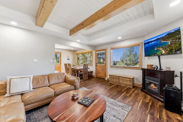 a living room with furniture a rug and a large window