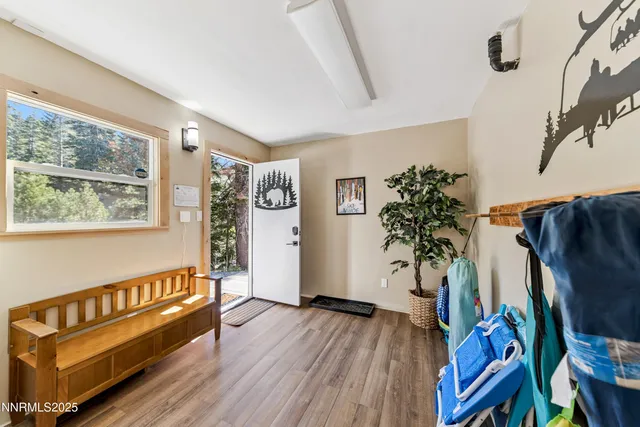 a view of an entryway with wooden floor and a potted plant
