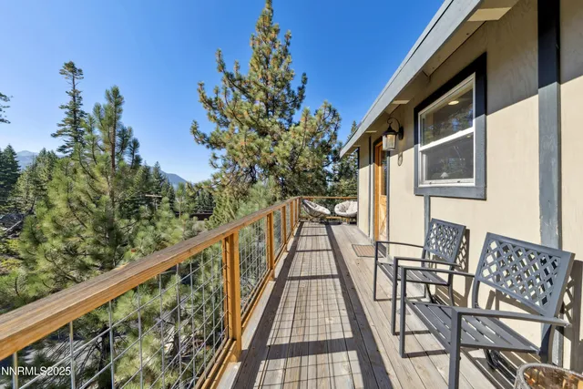 a view of balcony with wooden floor and seating space