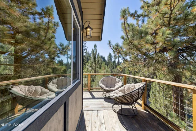 a balcony with wooden floor and furniture