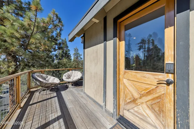 a view of a balcony with furniture and wooden floor