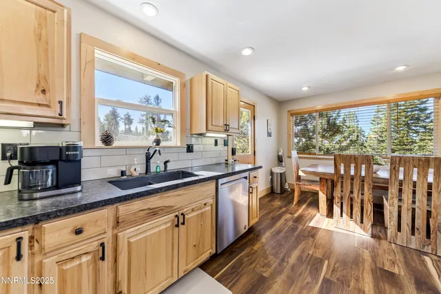a kitchen with lots of counter top space and wooden floor