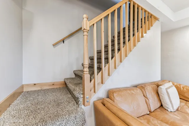 a view of staircase with rug