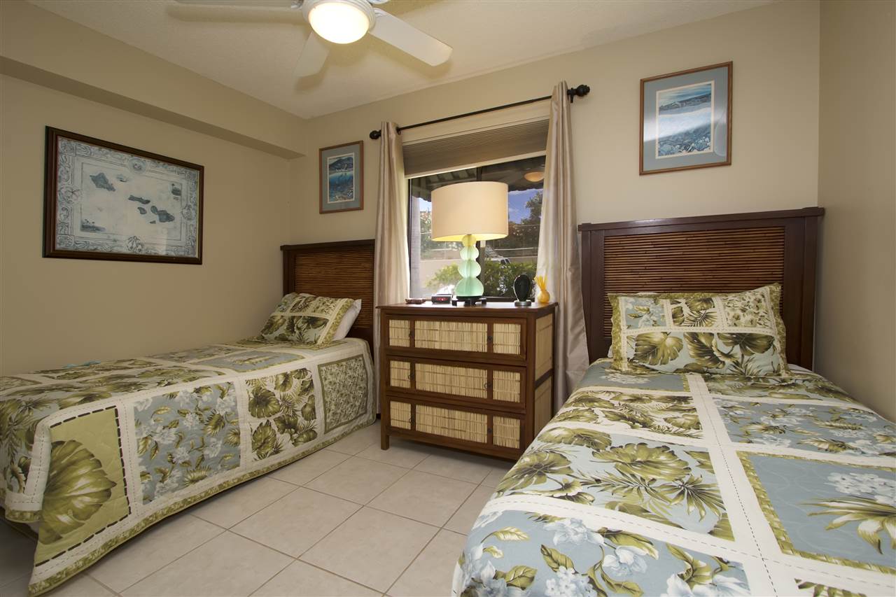2219 South Kihei Road, Unit B102 Kihei, HI 96753 - Photo 11 of 30 a bedroom with a bed and a chandelier