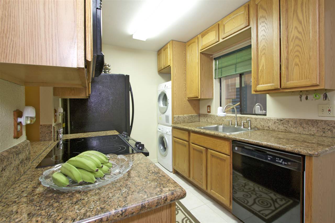 2219 South Kihei Road, Unit B102 Kihei, HI 96753 - Photo 16 of 30 a kitchen with a sink and a refrigerator