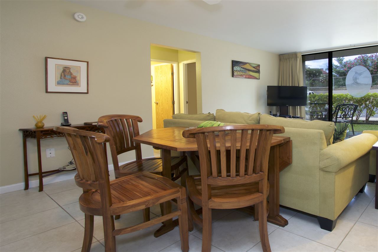 2219 South Kihei Road, Unit B102 Kihei, HI 96753 - Photo 19 of 30 a view of a dining room with furniture and a floor to ceiling window