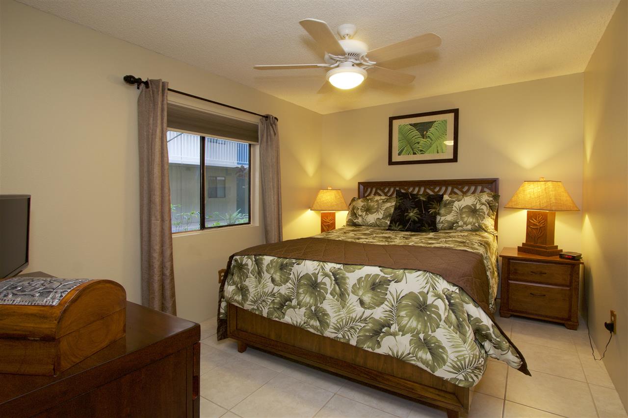 2219 South Kihei Road, Unit B102 Kihei, HI 96753 - Photo 2 of 30 a bedroom with a bed and a chandelier