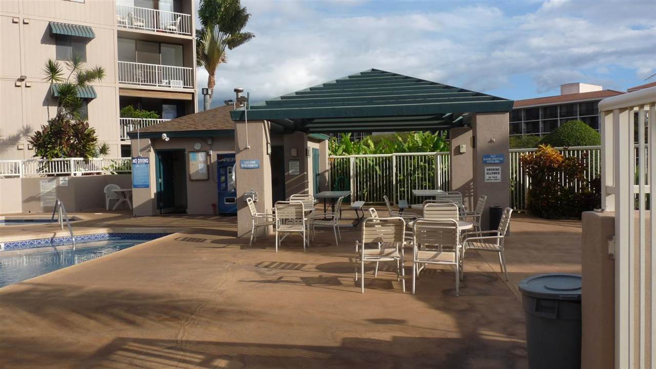 2219 South Kihei Road, Unit B102 Kihei, HI 96753 - Photo 22 of 30 a table and chairs in front of building