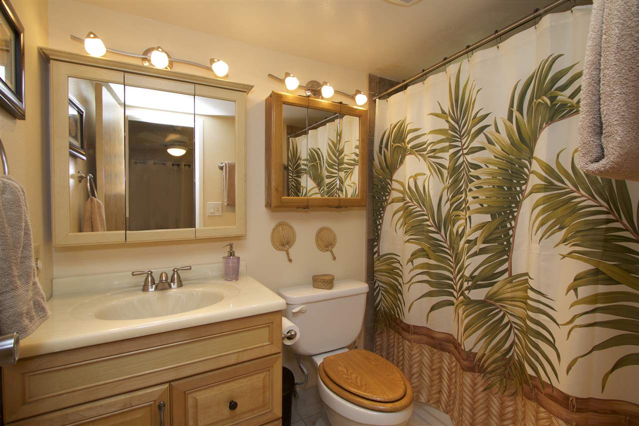 2219 South Kihei Road, Unit B102 Kihei, HI 96753 - Photo 10 of 30 a bathroom with a granite countertop sink a toilet and a mirror