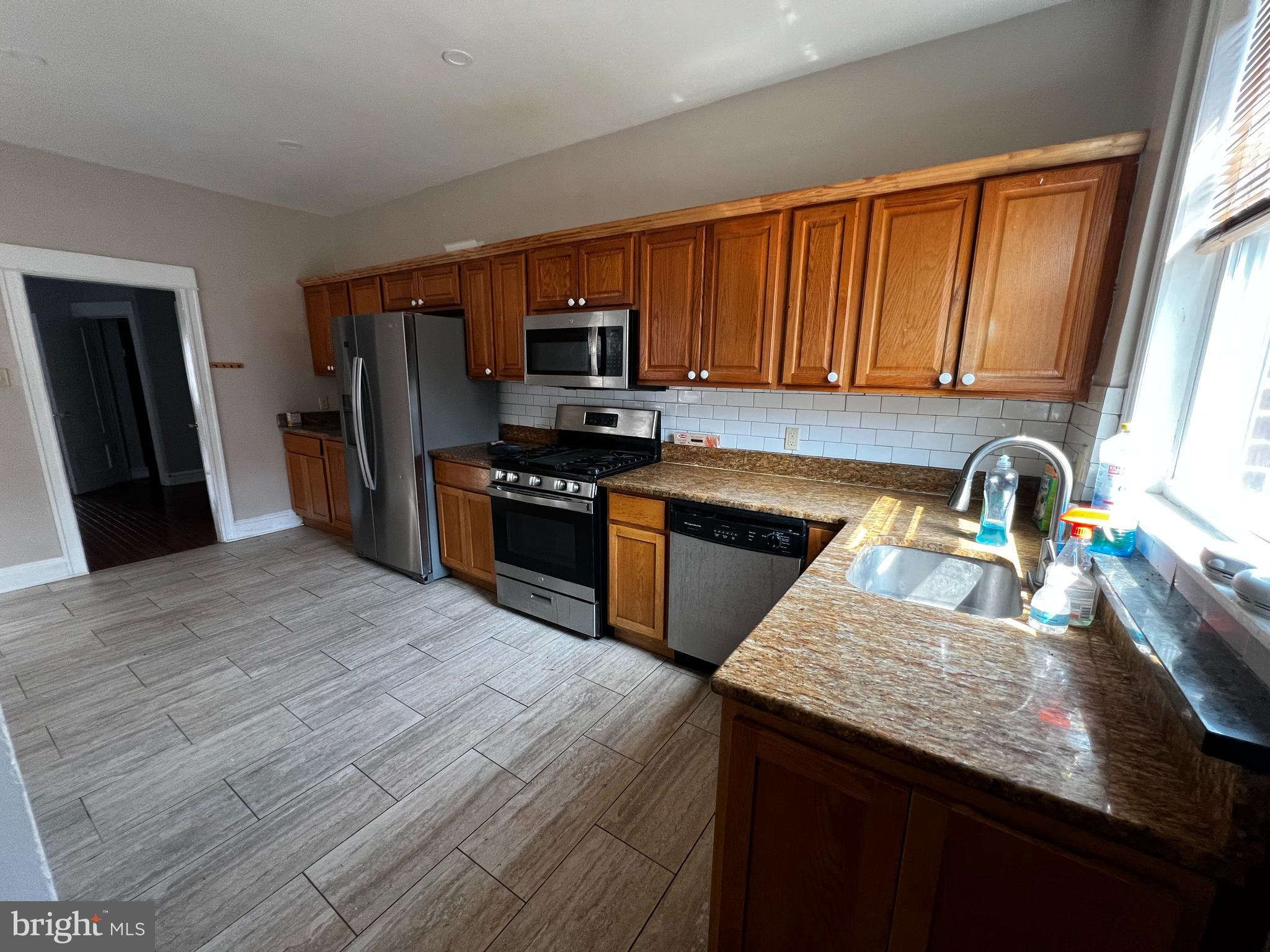 3340 Cottman Avenue Philadelphia, PA 19149 - Photo 3 of 42 a kitchen with stainless steel appliances granite countertop a sink stove refrigerator and a window