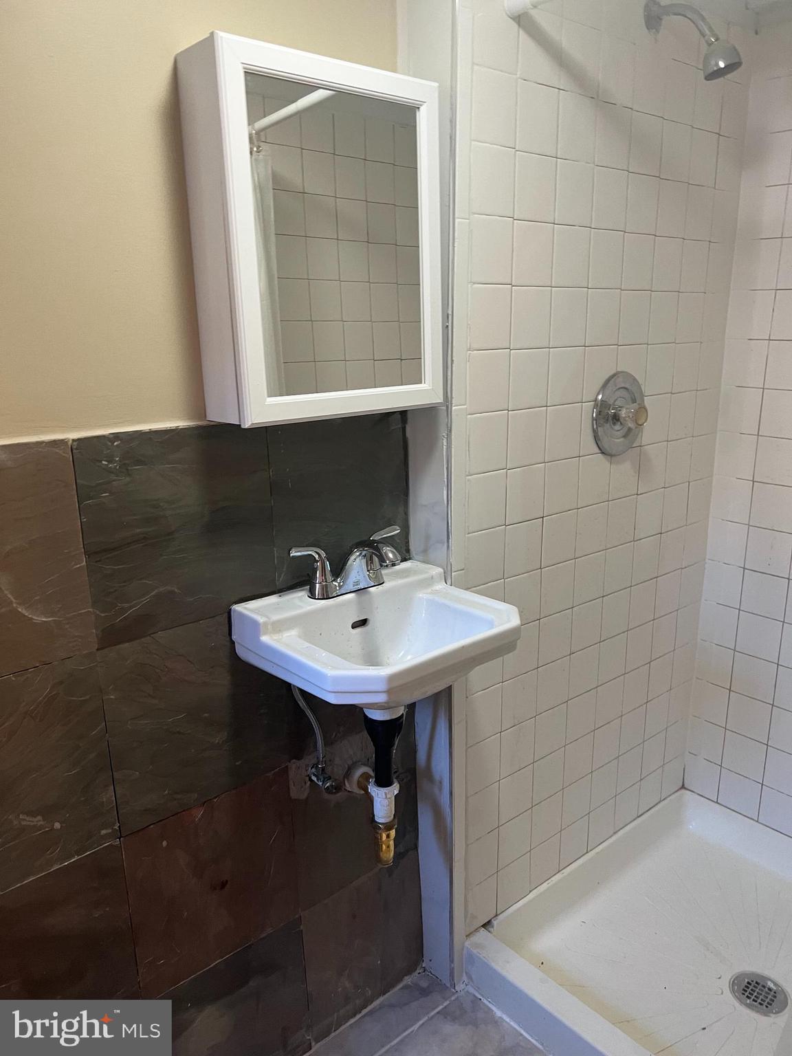 3340 Cottman Avenue Philadelphia, PA 19149 - Photo 7 of 42 a bathroom with a sink a mirror and shower