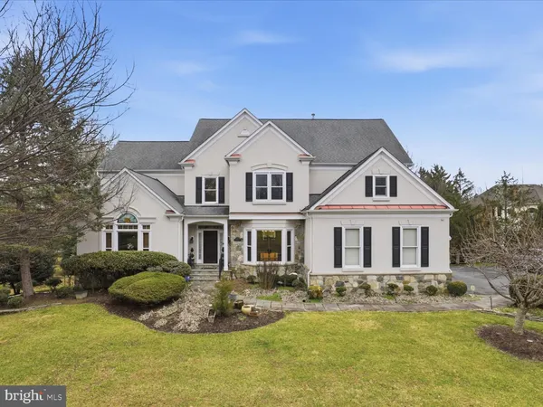 a front view of a house with swimming pool and porch