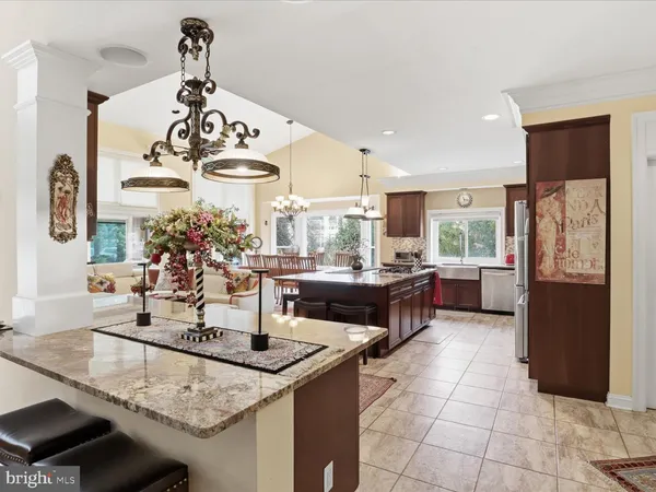 a kitchen with stainless steel appliances granite countertop a sink and a refrigerator