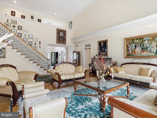 a living room with furniture a rug and a chandelier
