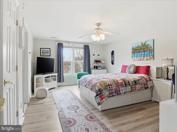 a spacious bedroom with a large bed and a flat screen tv