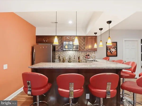 a kitchen with cabinets a sink and chairs