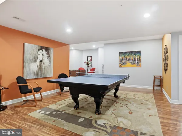 a living room with furniture a rug and a wall painting