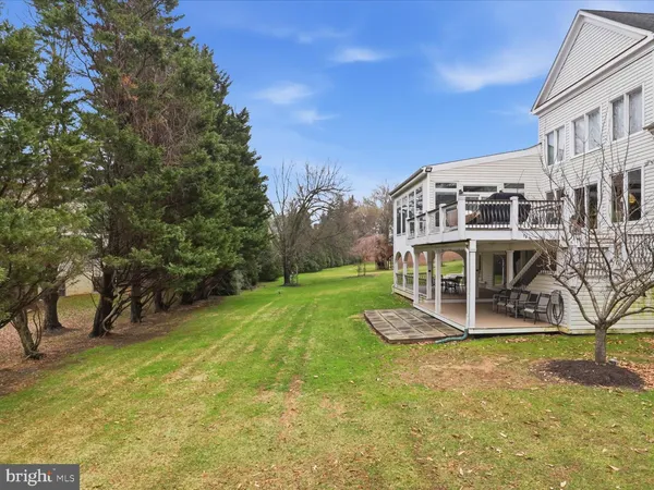 a view of a house with a yard balcony and sitting area