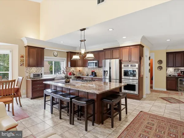a large kitchen with a table and chairs