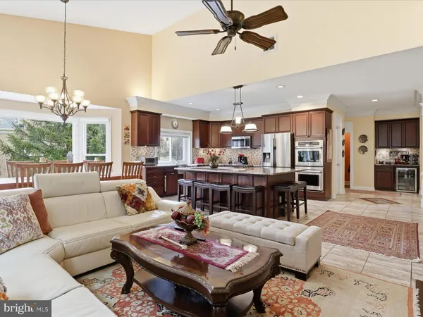 a living room with furniture and kitchen view