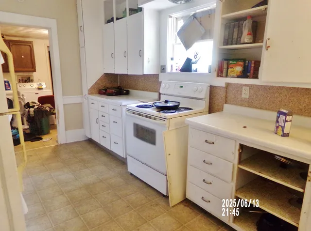 a kitchen with a stove and cabinets
