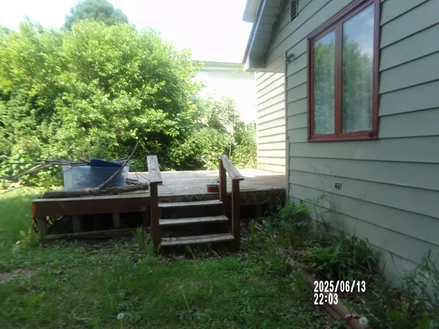 a view of a wooden bench sitting in middle of a yard