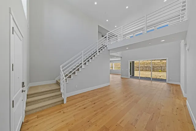 a view of entryway and hall with wooden floor