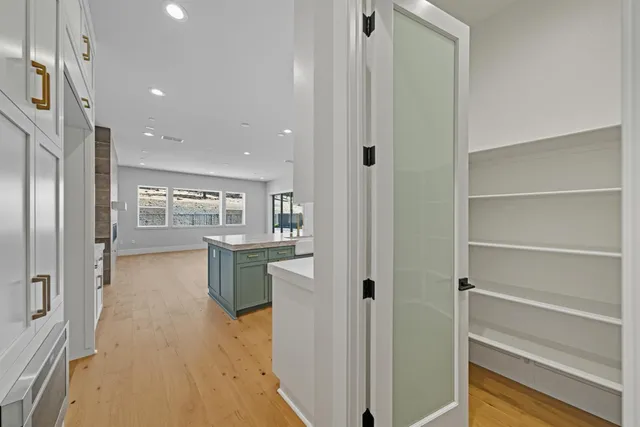 a view of a hallway with wooden shelves
