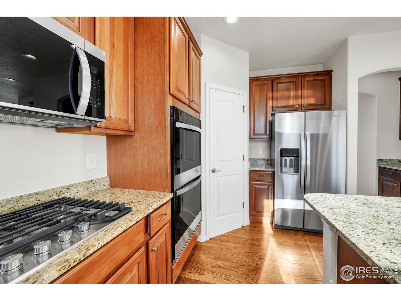 1936 Alpine Drive Erie, CO 80516 - Photo 12 of 47 a kitchen with stainless steel appliances granite countertop a refrigerator and a stove top oven