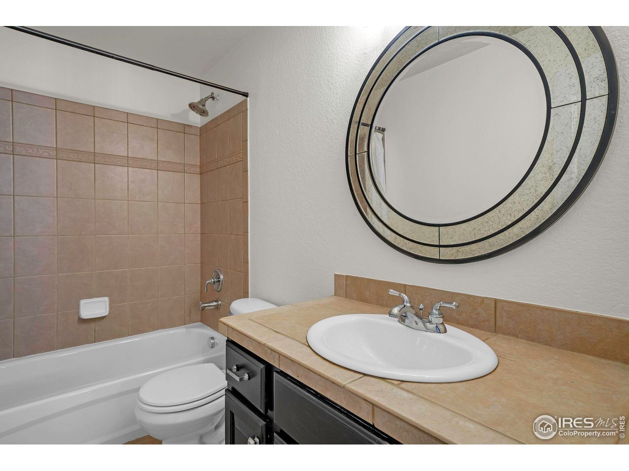 1936 Alpine Drive Erie, CO 80516 - Photo 20 of 47 a bathroom with a sink a toilet and a mirror