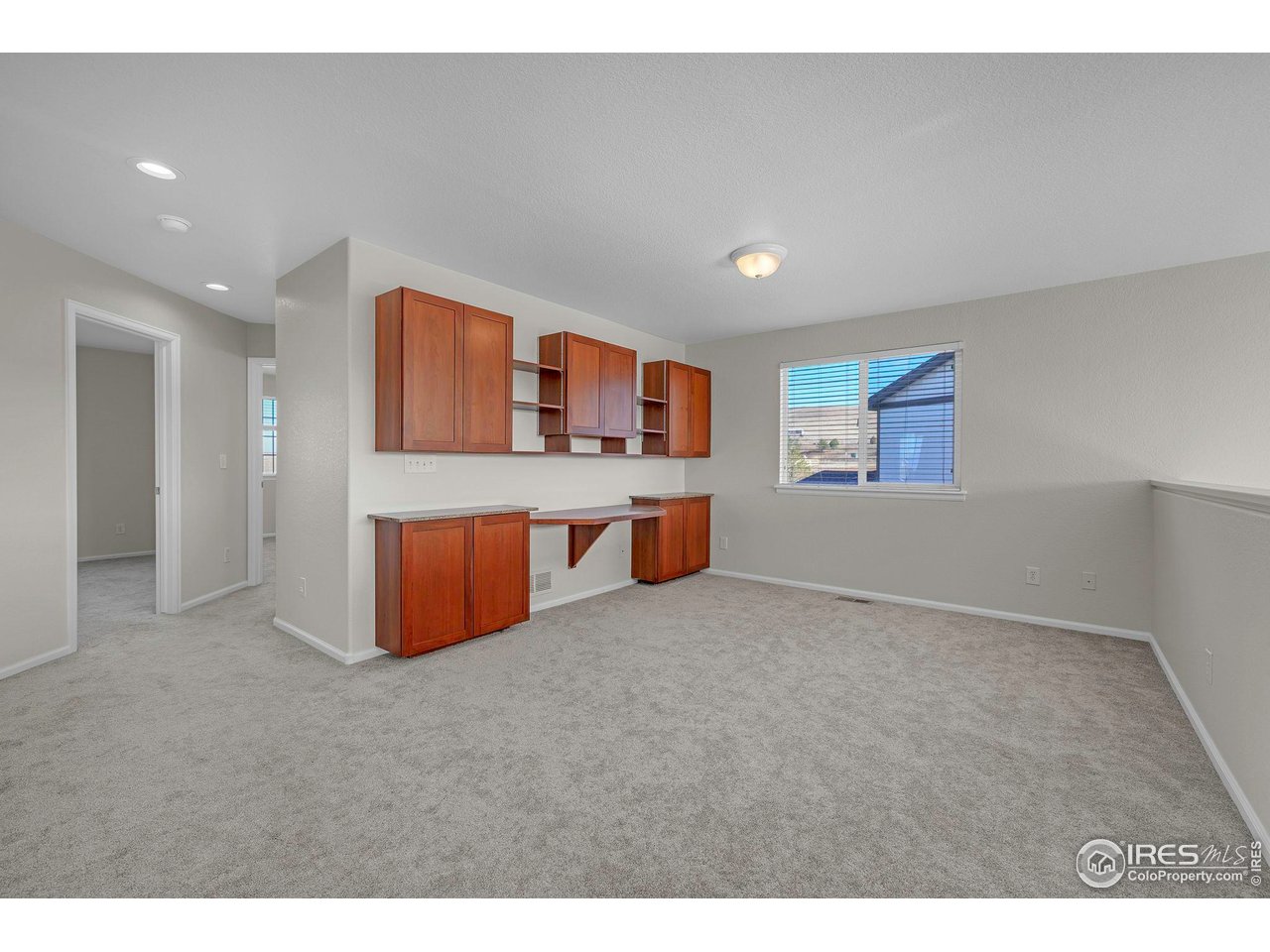 1936 Alpine Drive Erie, CO 80516 - Photo 22 of 47 a large bedroom with a large bed and window