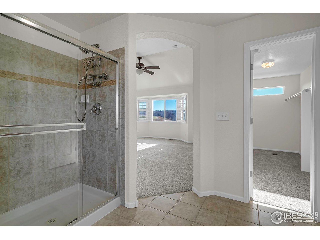 1936 Alpine Drive Erie, CO 80516 - Photo 28 of 47 a bathroom with a glass shower door