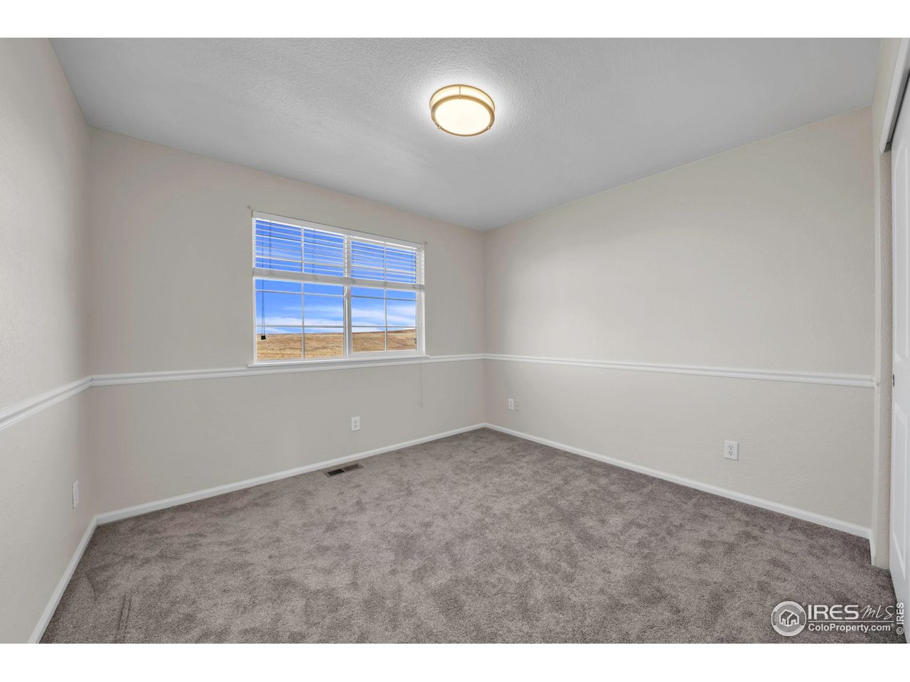 1936 Alpine Drive Erie, CO 80516 - Photo 32 of 47 a view of an empty room with a window