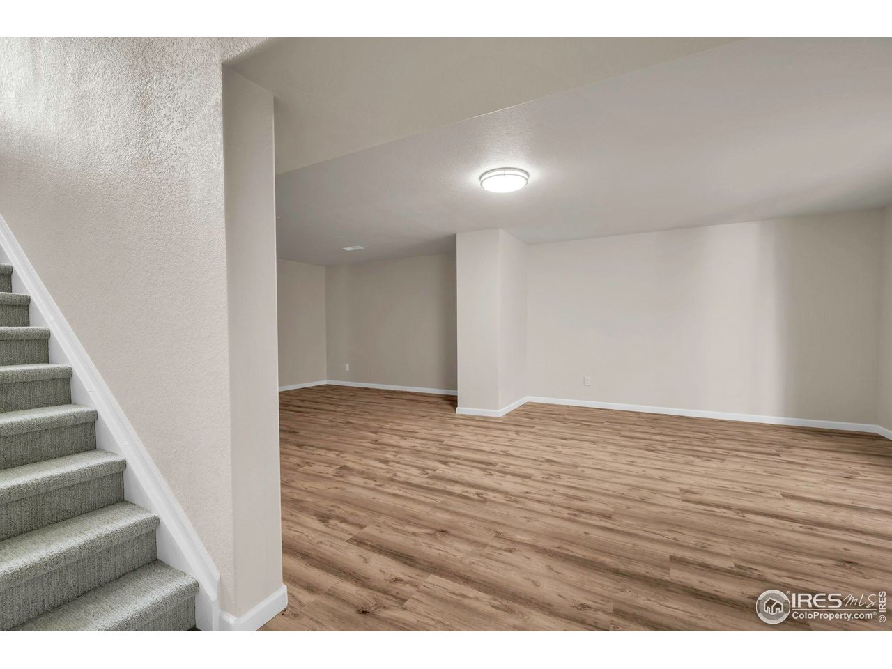 1936 Alpine Drive Erie, CO 80516 - Photo 34 of 47 a view of an empty room with wooden floor