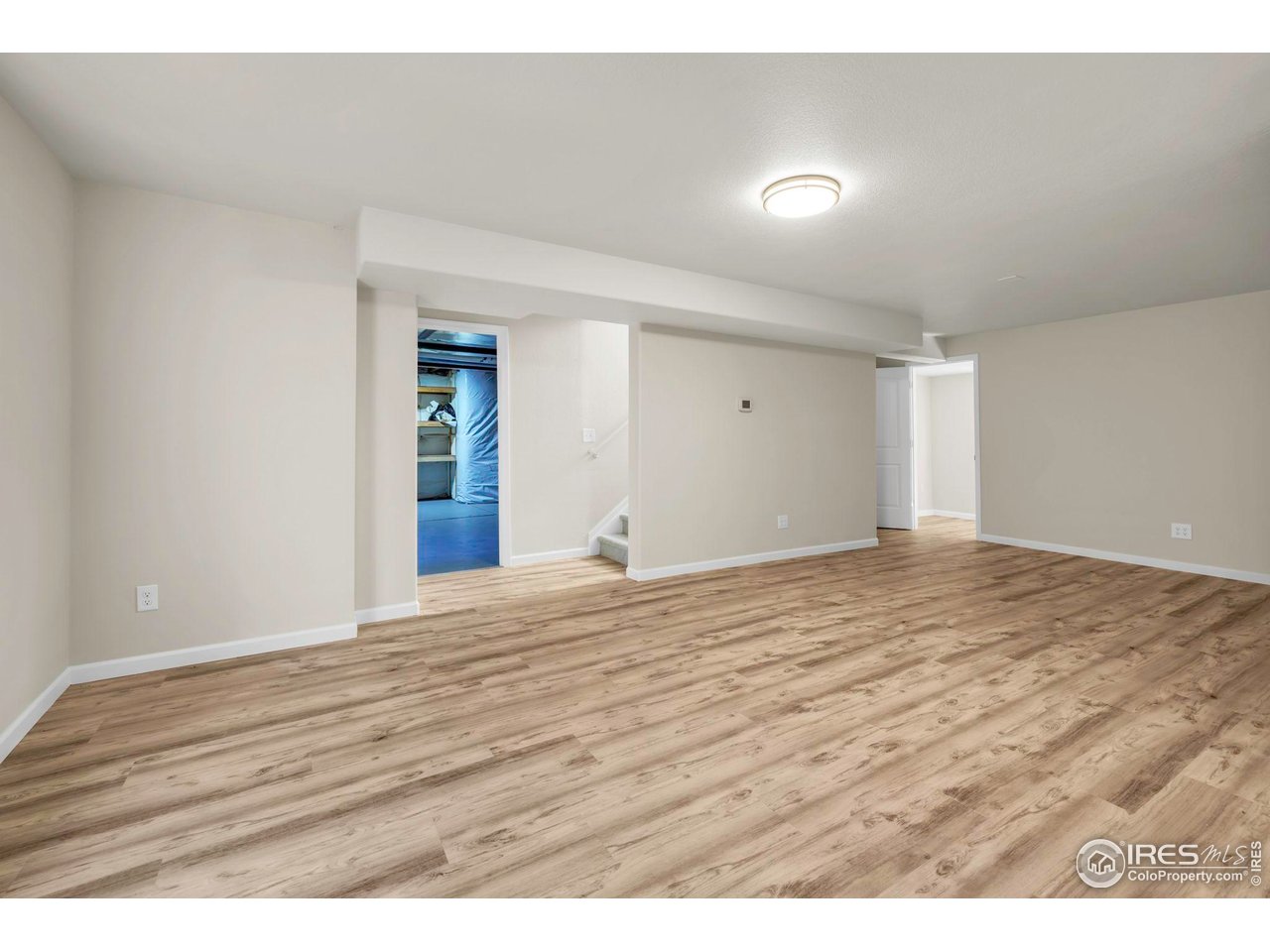 1936 Alpine Drive Erie, CO 80516 - Photo 35 of 47 a view of an empty room and wooden floor