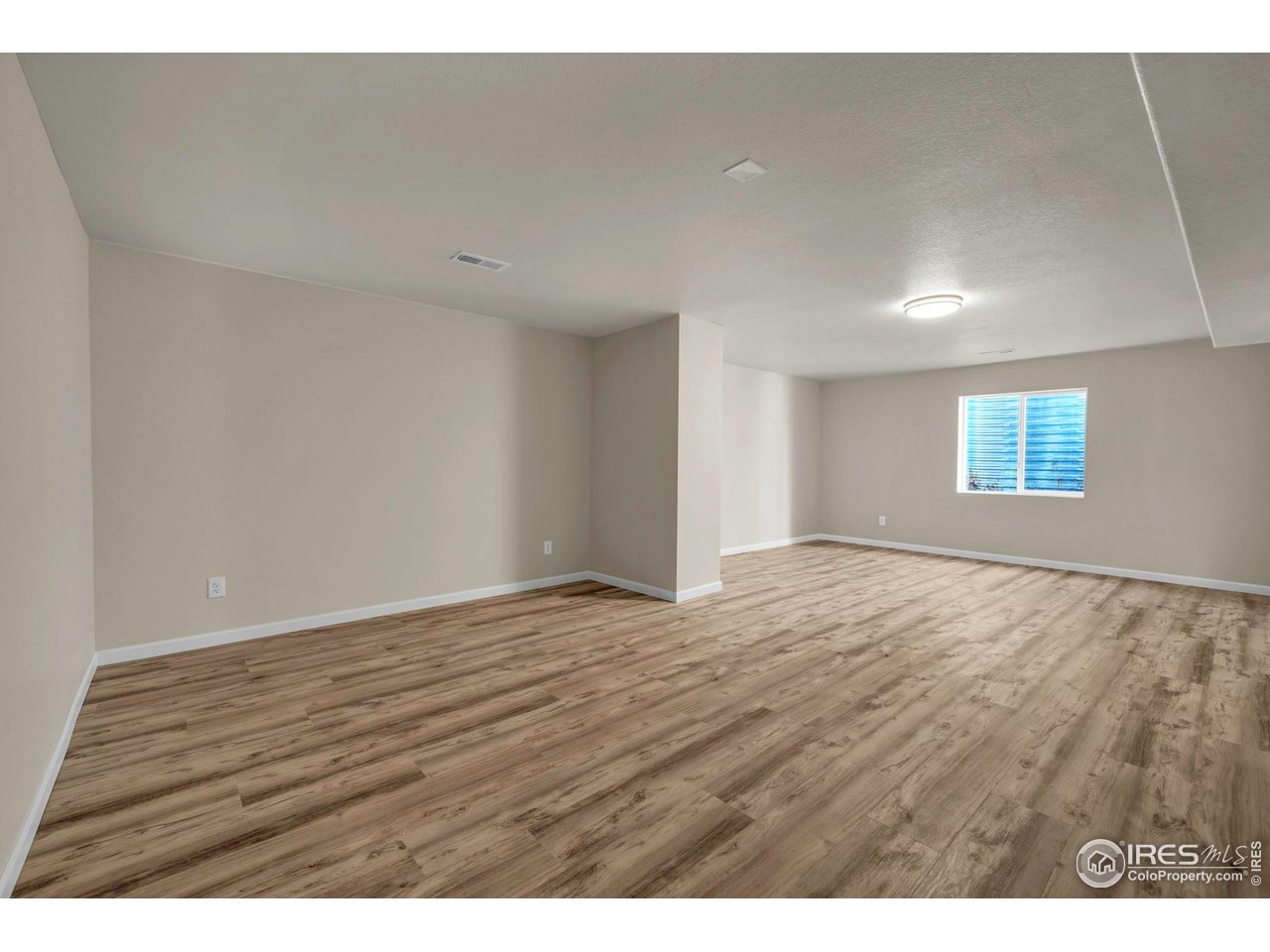 1936 Alpine Drive Erie, CO 80516 - Photo 36 of 47 a view of an empty room with wooden floor and a window