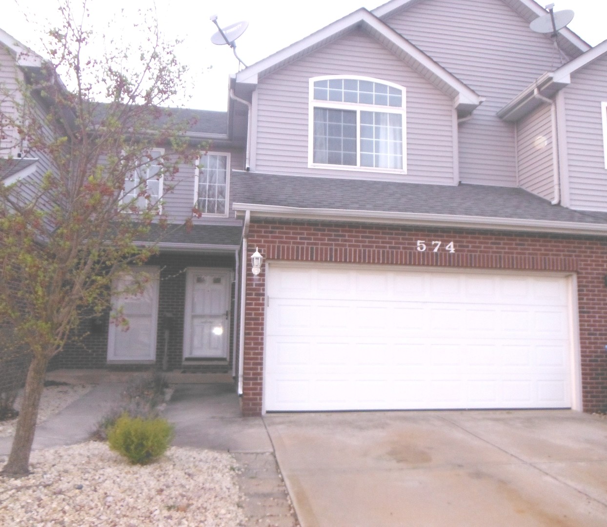 574 Boulder Drive Morris, IL 60450 - Photo 1 of 13 a front view of a house with a yard and garage