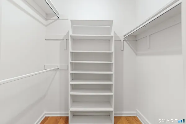 a view of walk in closet with empty racks