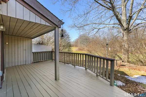 a view of a balcony with wooden floor