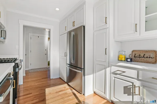 a kitchen with stainless steel appliances granite countertop a refrigerator and a stove top oven