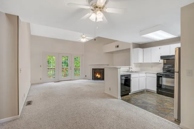 a view of a kitchen with a sink a refrigerator and window