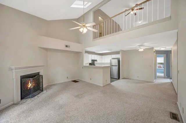 a view of a livingroom with a fireplace and fan