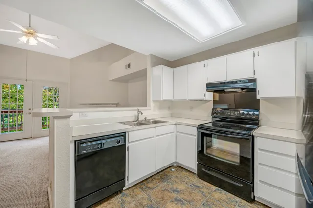 a kitchen with a stove and a sink